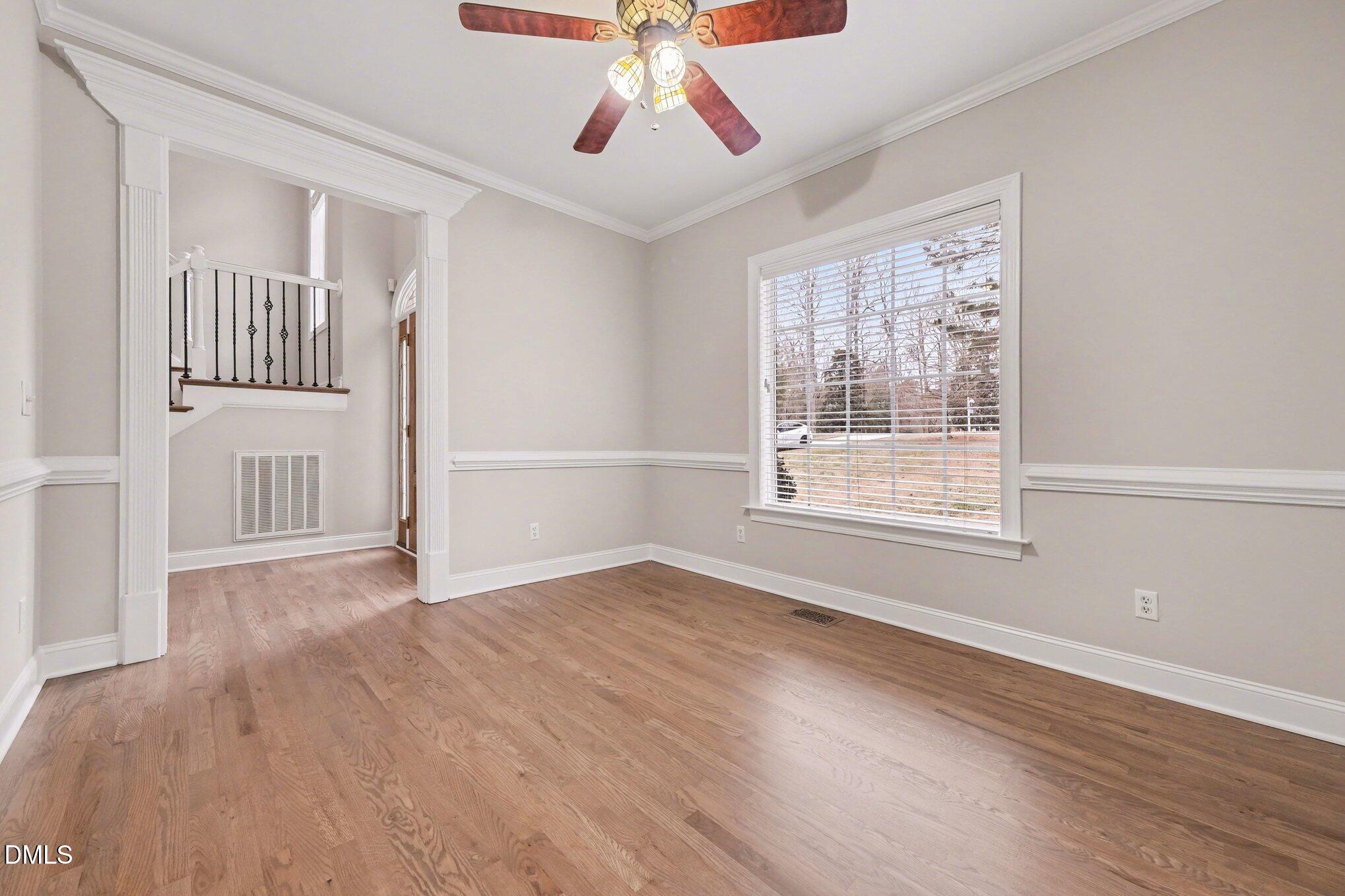 4613 Cherrybark Lane Raleigh, NC 27616 - Photo 10 of 27 a view of an empty room with wooden floor and a window