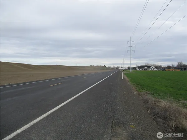 a view of a big yard with lots of green space