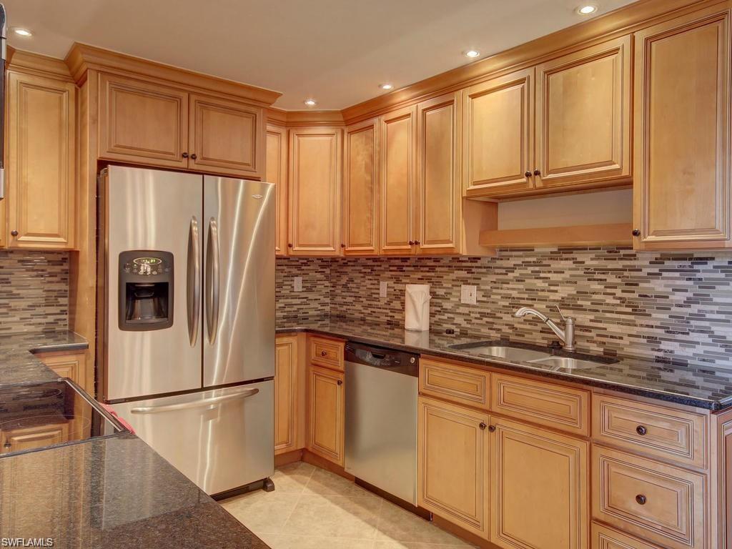 a white refrigerator freezer sitting inside of a kitchen