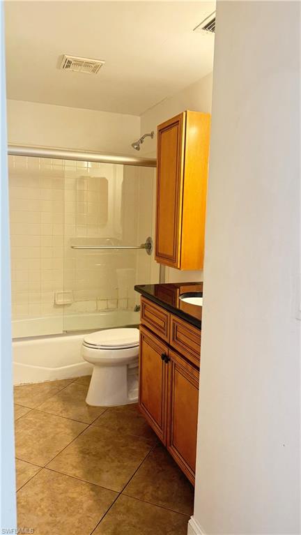 4912 Hawaii Boulevard Naples, FL 34112 - Photo 12 of 12 a bathroom with a granite countertop bathtub shower sink and toilet