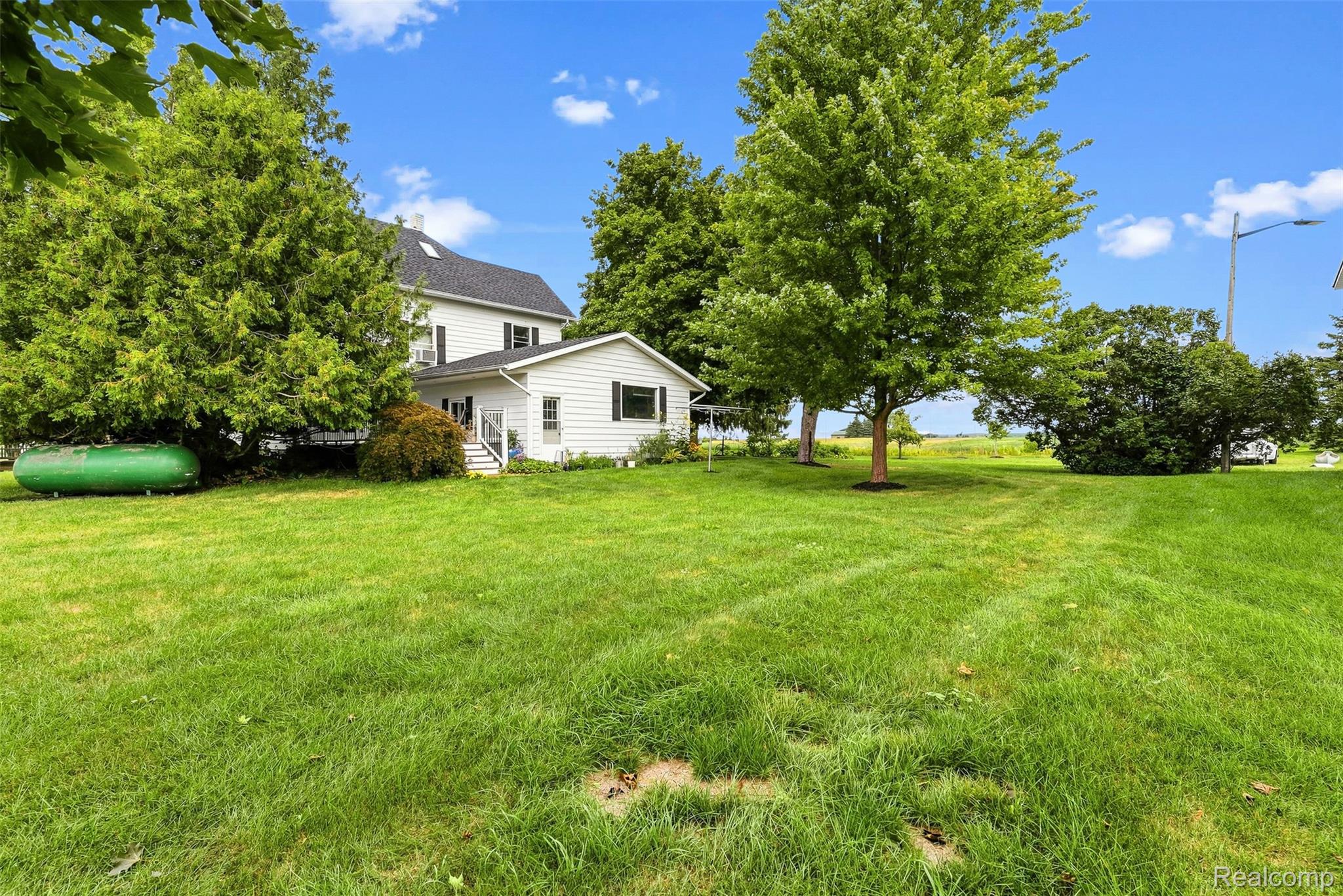 2971 Huron Line Road Cass City, MI 48726 - Photo 41 of 63 Expansive lawn with mature trees, offering a clear view of the surrounding landscape