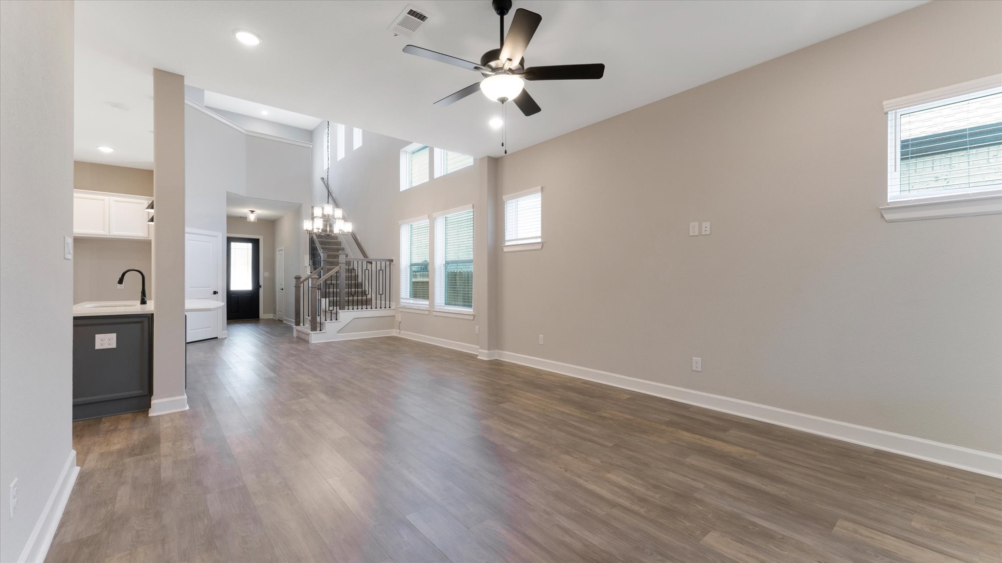 15607 Rising Wren Court Conroe, TX 77302 - Photo 17 of 40 a view of a hallway with wooden floor and a chandelier fan