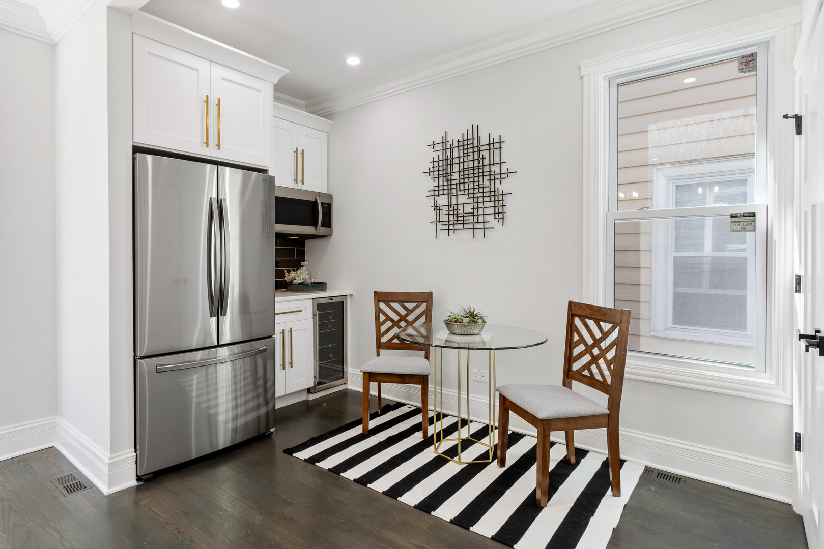 2743 North Ridgeway Avenue Chicago, IL 60647 - Photo 11 of 33 a kitchen with stainless steel appliances granite countertop a refrigerator and a stove top oven with wooden floor