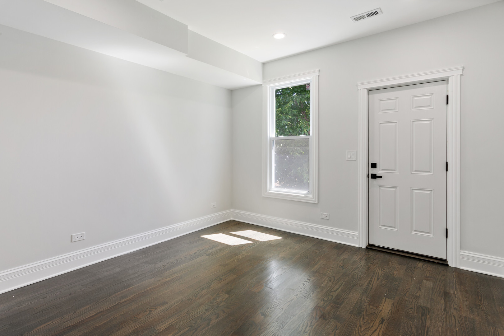 2743 North Ridgeway Avenue Chicago, IL 60647 - Photo 29 of 33 an empty room with wooden floor and windows