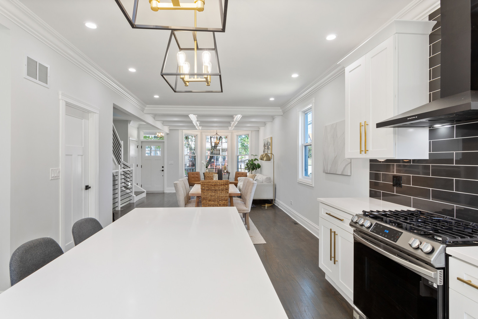 2743 North Ridgeway Avenue Chicago, IL 60647 - Photo 8 of 33 a large kitchen with stainless steel appliances granite countertop a stove a refrigerator a sink dishwasher with a dining table and chairs