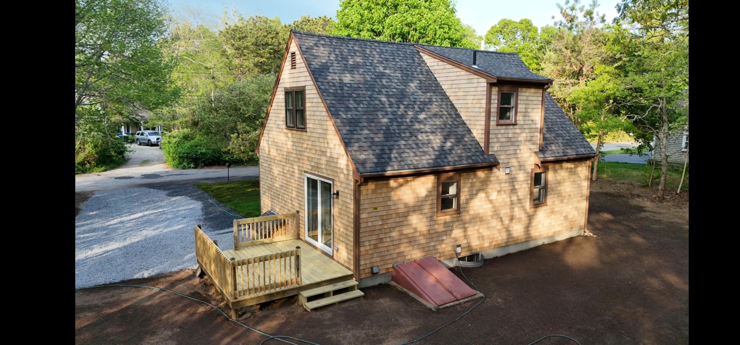 147 Chippingstone Road Marstons Mills, MA 02648 - Photo 12 of 23 a backyard of a house with table and chairs