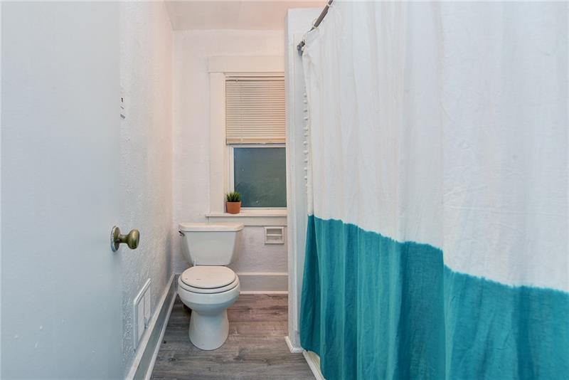 1548 Rutherford Avenue Pittsburgh, PA 15216 - Photo 20 of 24 New flooring fresh paint, and a privacy window make this bathroom bright & clean.
