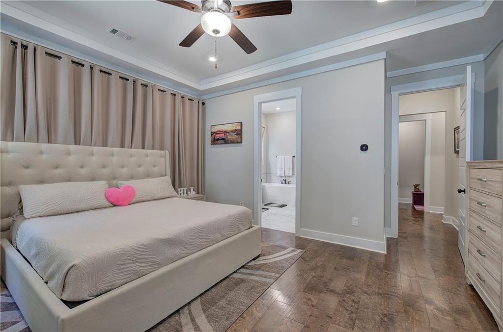 503 London Road Ball Ground, GA 30107 - Photo 22 of 55 a bedroom with a large bed and a chandelier