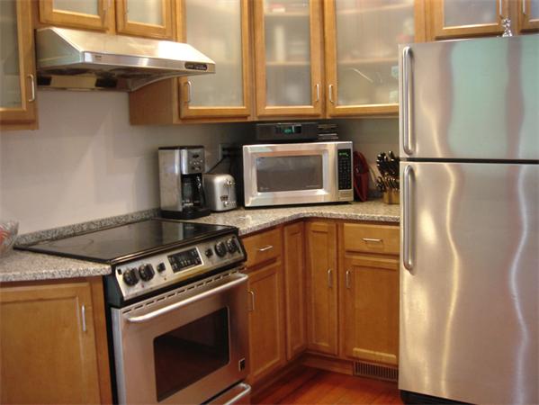 20 York Street Lexington, MA 02420 - Photo 5 of 7 a kitchen with stainless steel appliances granite countertop a refrigerator a stove and a microwave