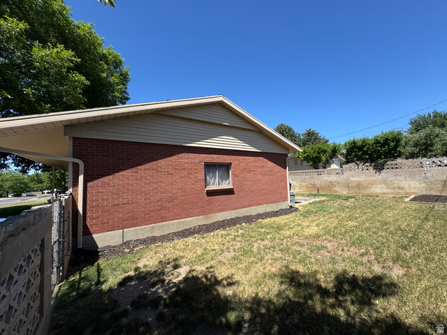1611 South 75 East Bountiful, UT 84010 - Photo 4 of 6 Brick exterior with light-colored siding and a carport structure