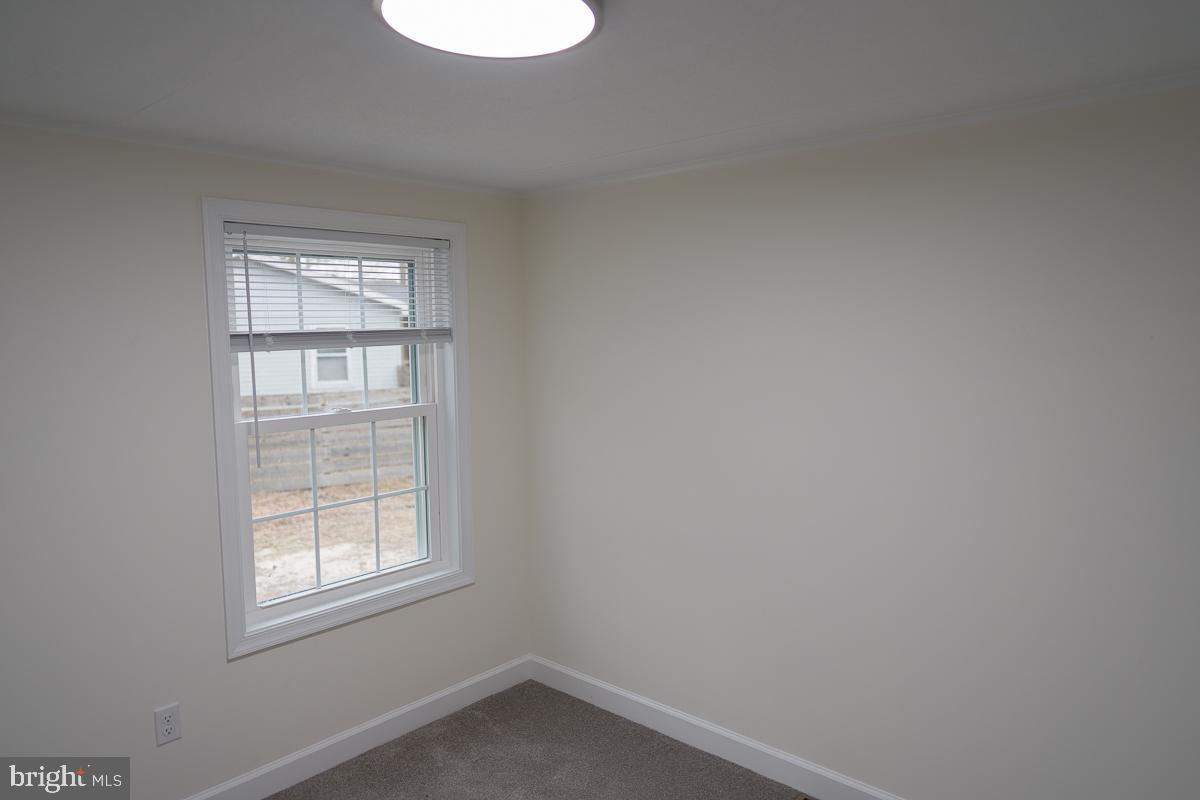 16449 Polk Road Bridgeville, DE 19933 - Photo 11 of 22 an empty room with a window