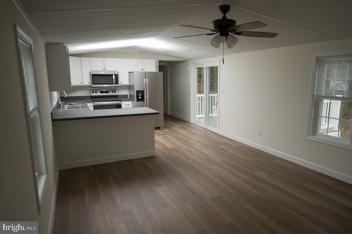 16449 Polk Road Bridgeville, DE 19933 - Photo 3 of 22 a kitchen with stainless steel appliances a stove and a refrigerator