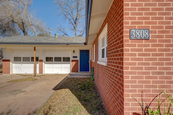 a view of a brick house with a large window