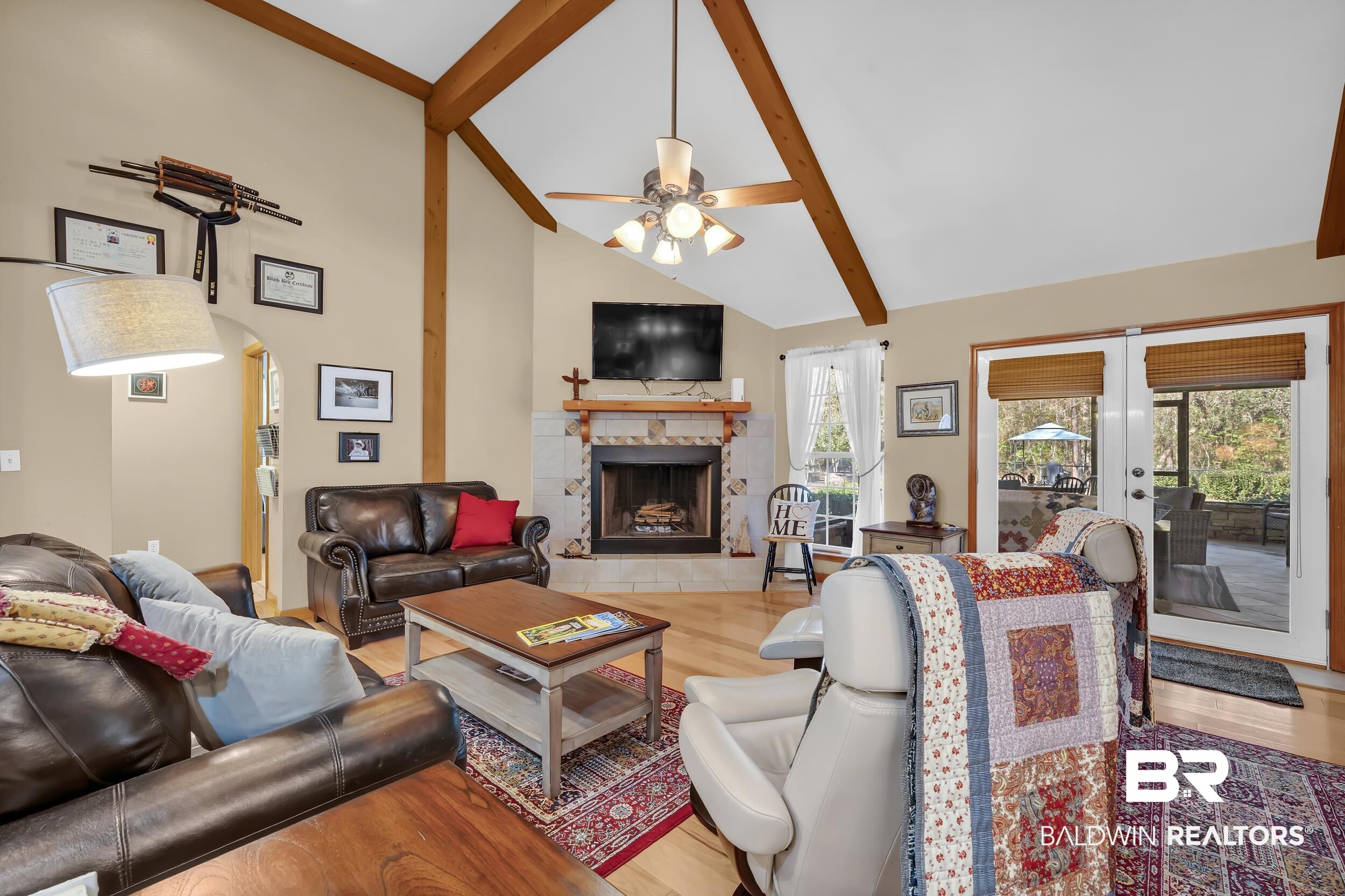 22929 Highway 98 Foley, AL 36535 - Photo 10 of 54 Living room with a tile fireplace, lofted ceiling, light wood-style floors, arched walkways, and a ceiling fan