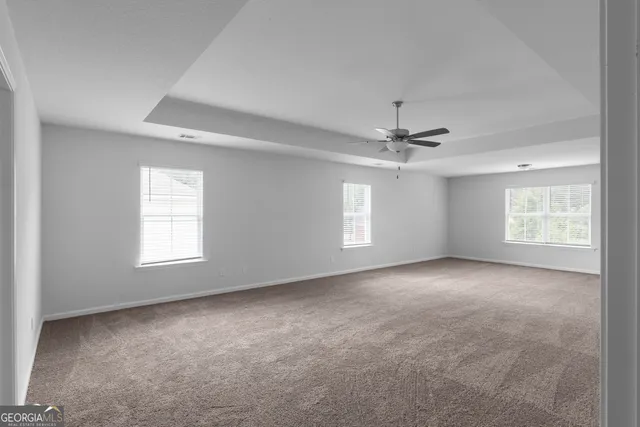 a view of a livingroom with a ceiling fan and window