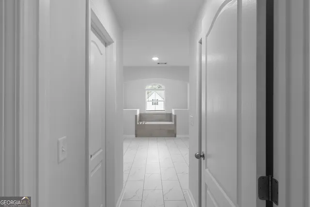 a view of hallway with stairs and wooden floor