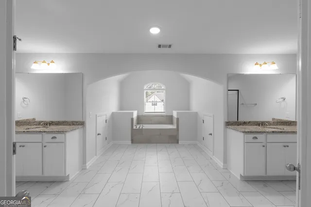 a view of a kitchen with white cabinets