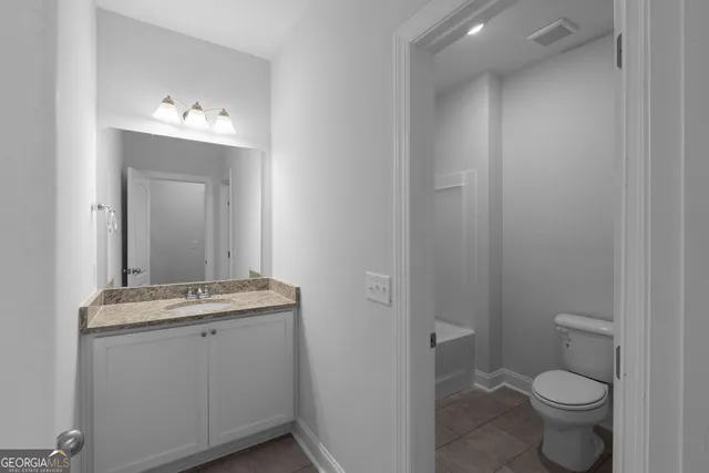a bathroom with a sink toilet and vanity