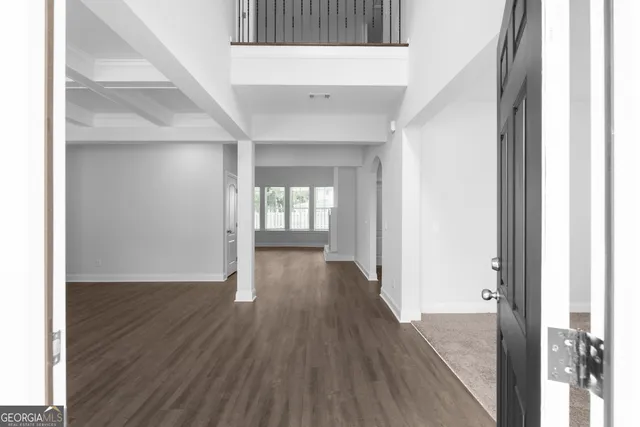 a view of a hallway with wooden floor