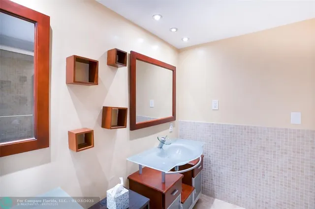 a bathroom with a sink a mirror and a toilet