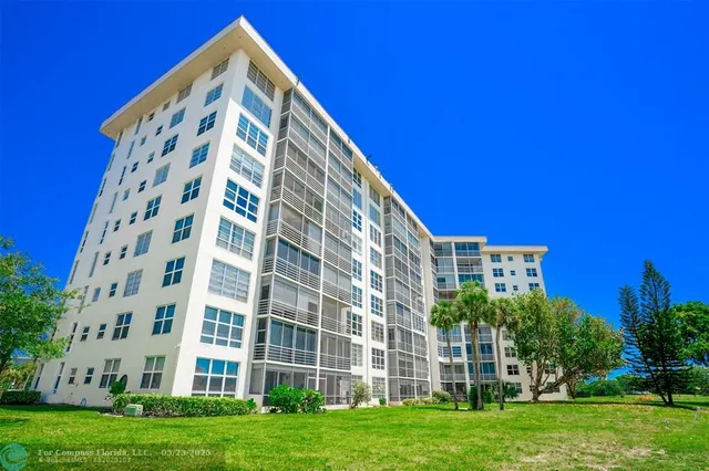 a view of a building with a yard