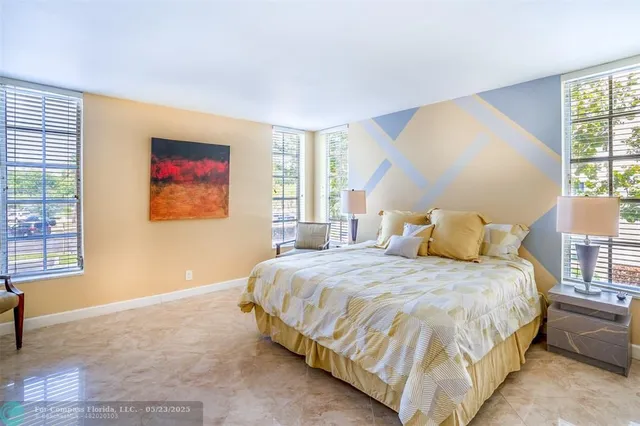 a bedroom with bed and a window