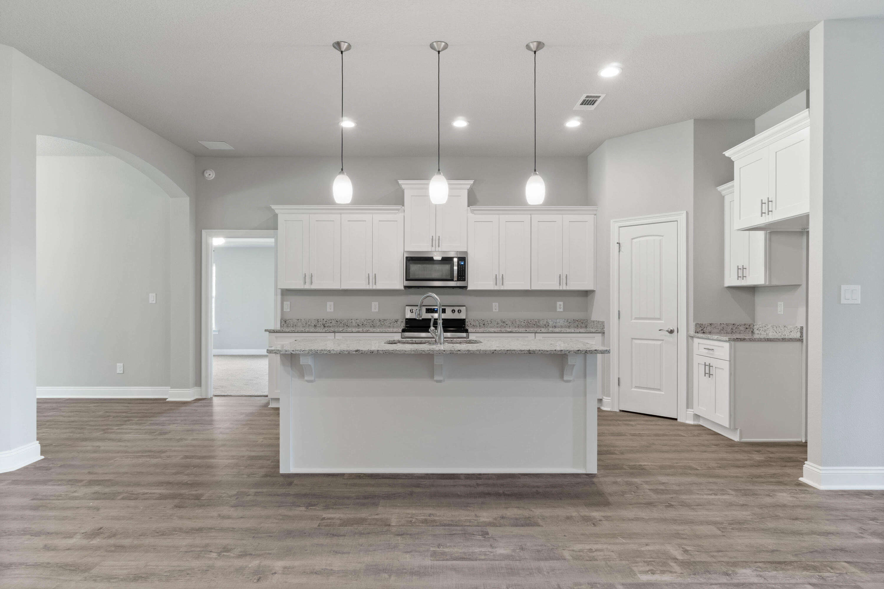 3548 Bob Tolbert Road Navarre, FL 32566 - Photo 11 of 47 a view of a kitchen with kitchen island a sink stainless steel appliances and cabinets
