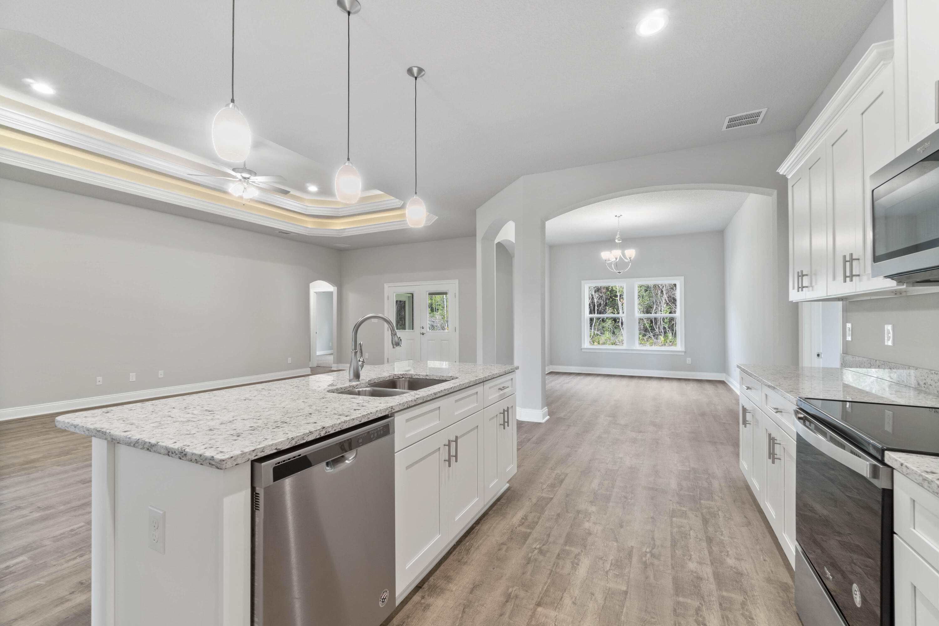 3548 Bob Tolbert Road Navarre, FL 32566 - Photo 13 of 47 a kitchen with a sink stove and wooden floor