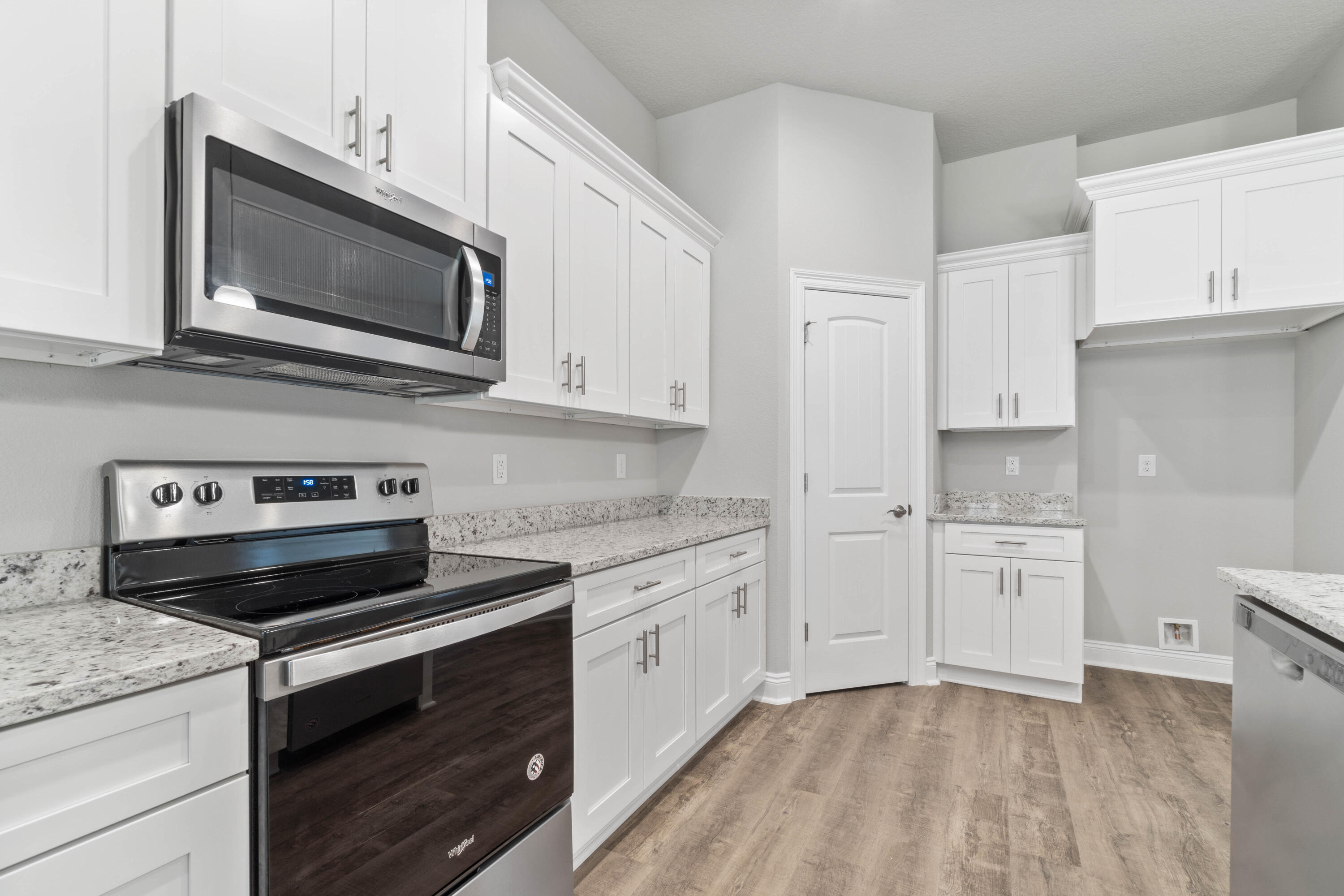 3548 Bob Tolbert Road Navarre, FL 32566 - Photo 15 of 47 a kitchen with granite countertop white cabinets and stainless steel appliances