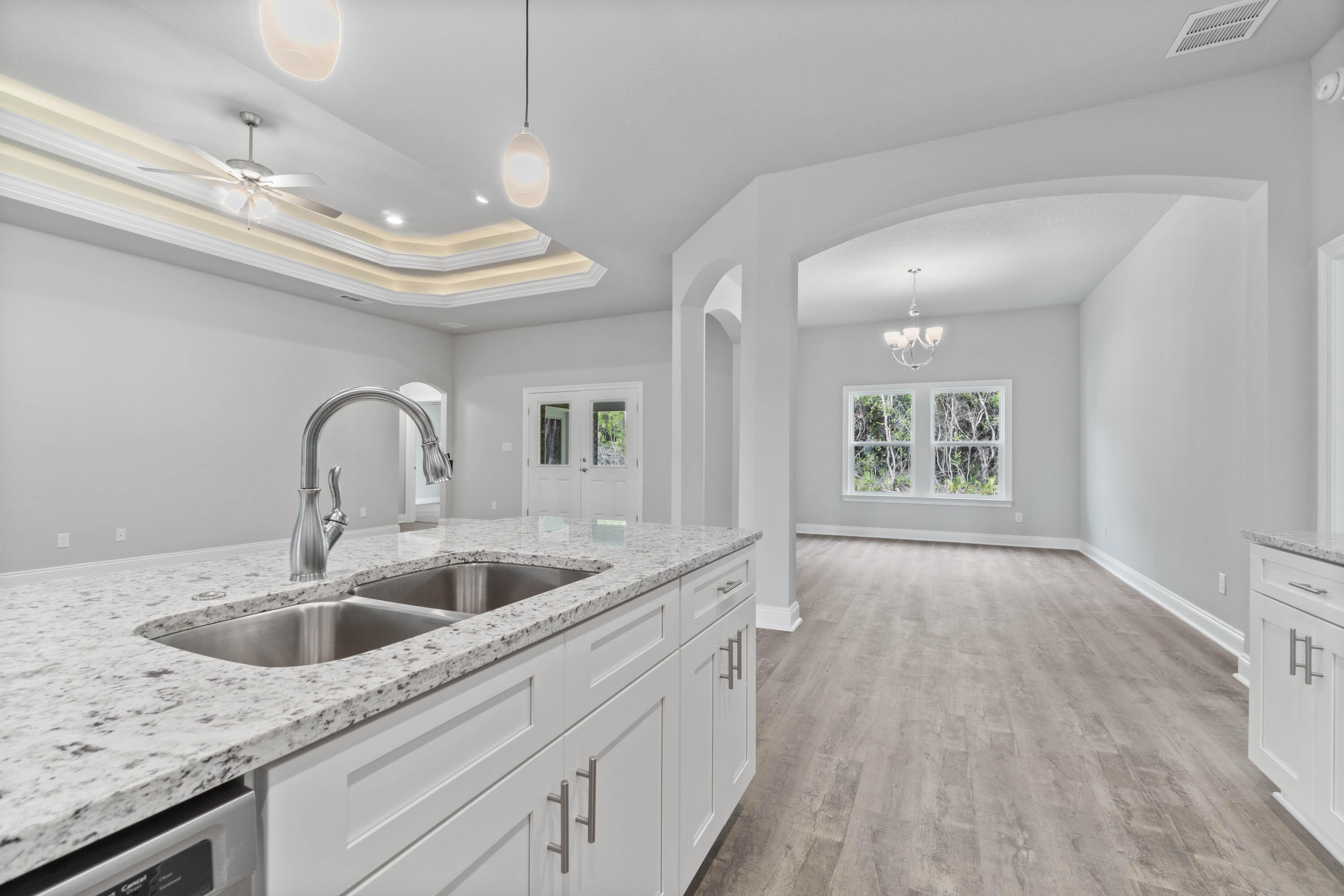 3548 Bob Tolbert Road Navarre, FL 32566 - Photo 16 of 47 a kitchen with a sink and chandelier