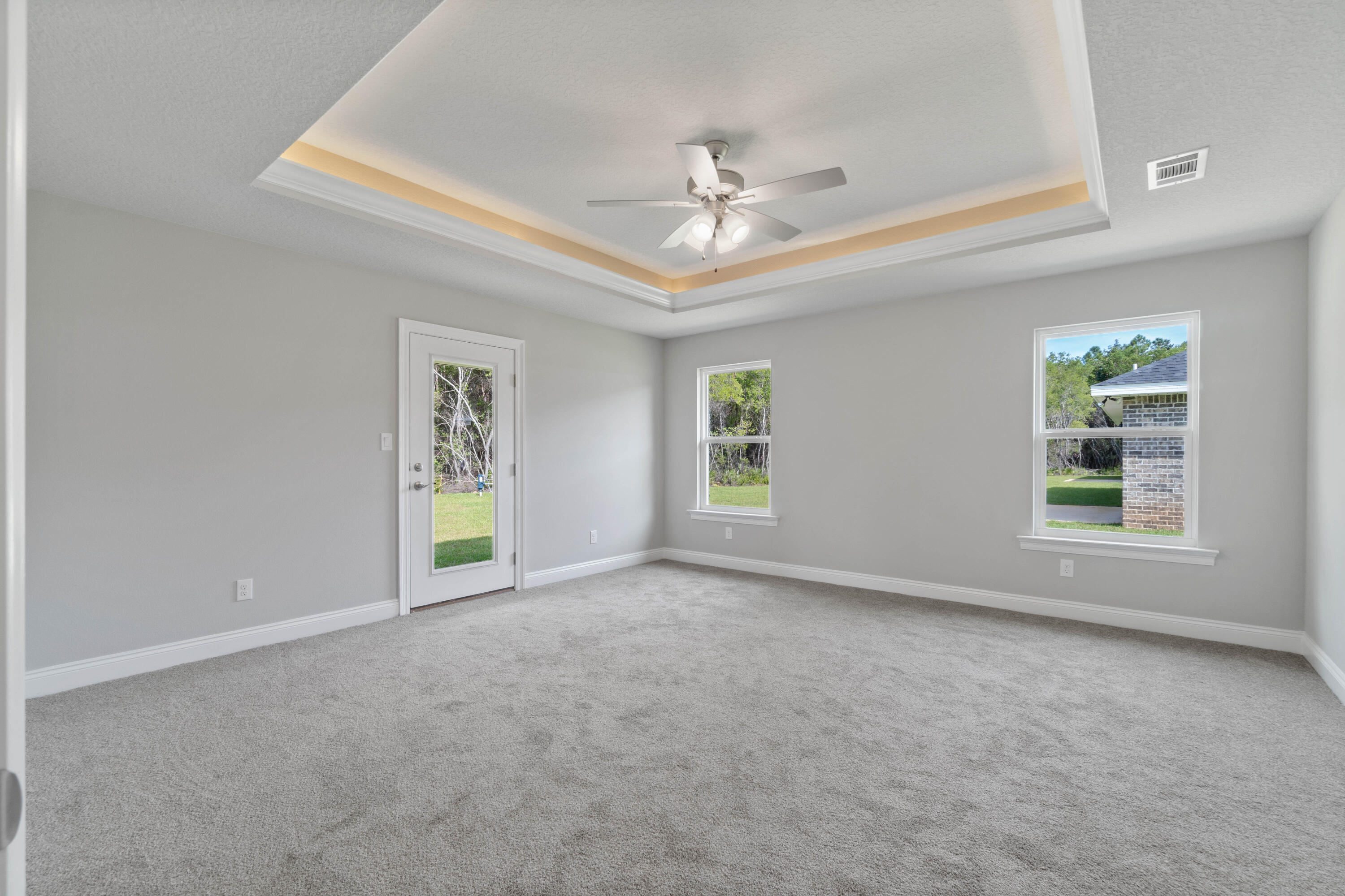 3548 Bob Tolbert Road Navarre, FL 32566 - Photo 19 of 47 an empty room with windows and fan
