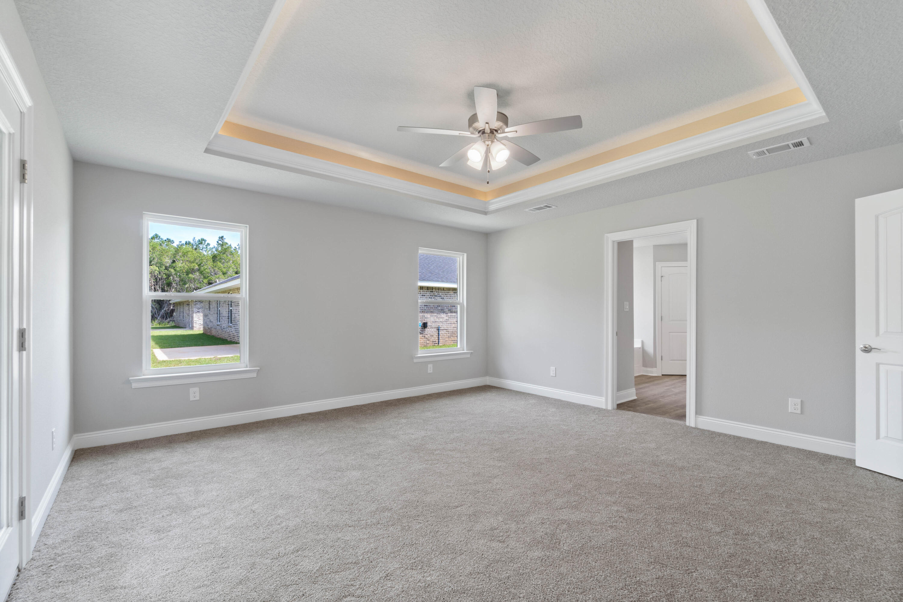 3548 Bob Tolbert Road Navarre, FL 32566 - Photo 20 of 47 an empty room with windows and fan