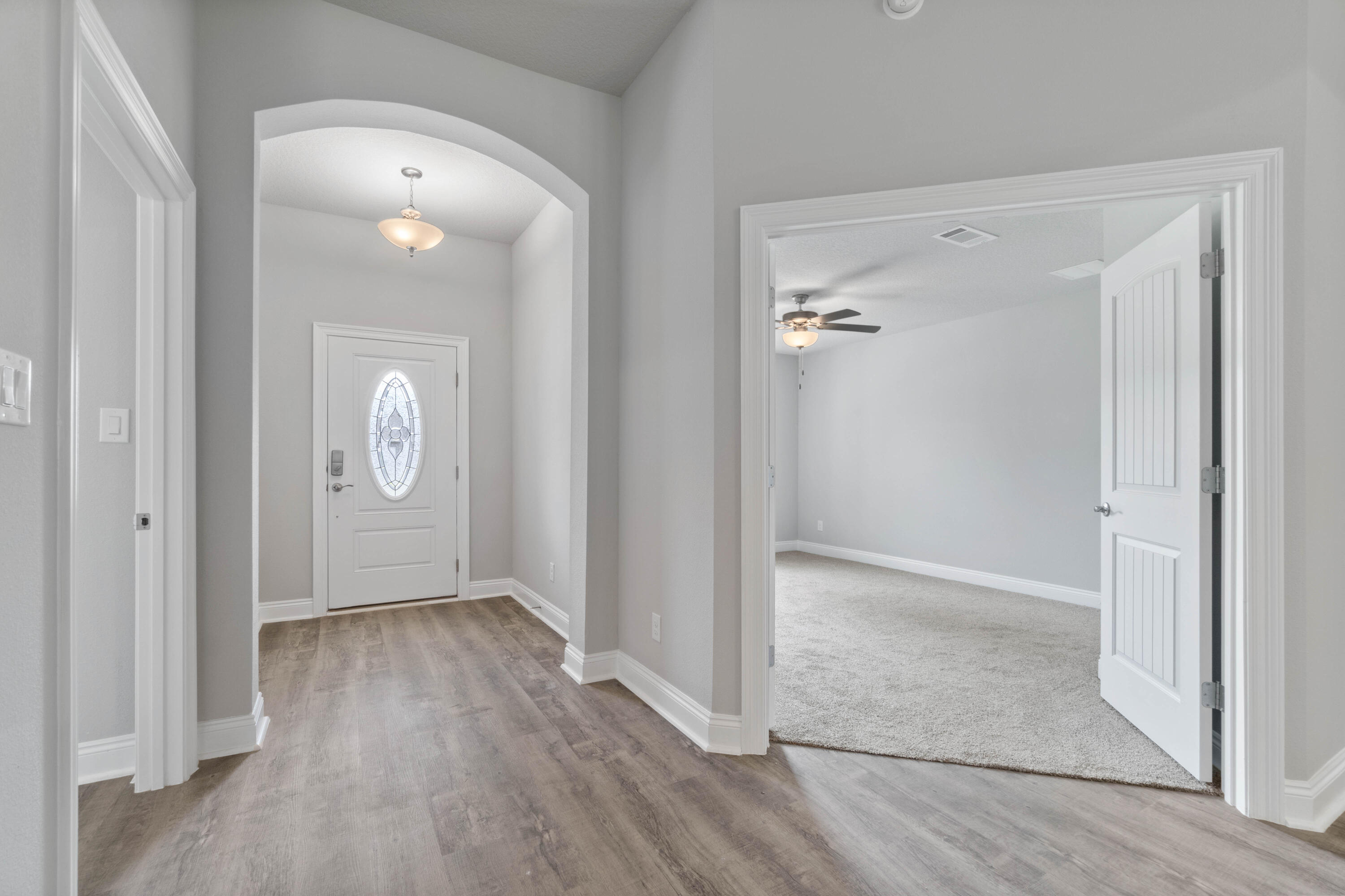 3548 Bob Tolbert Road Navarre, FL 32566 - Photo 2 of 47 an empty room with wooden floor and mirror