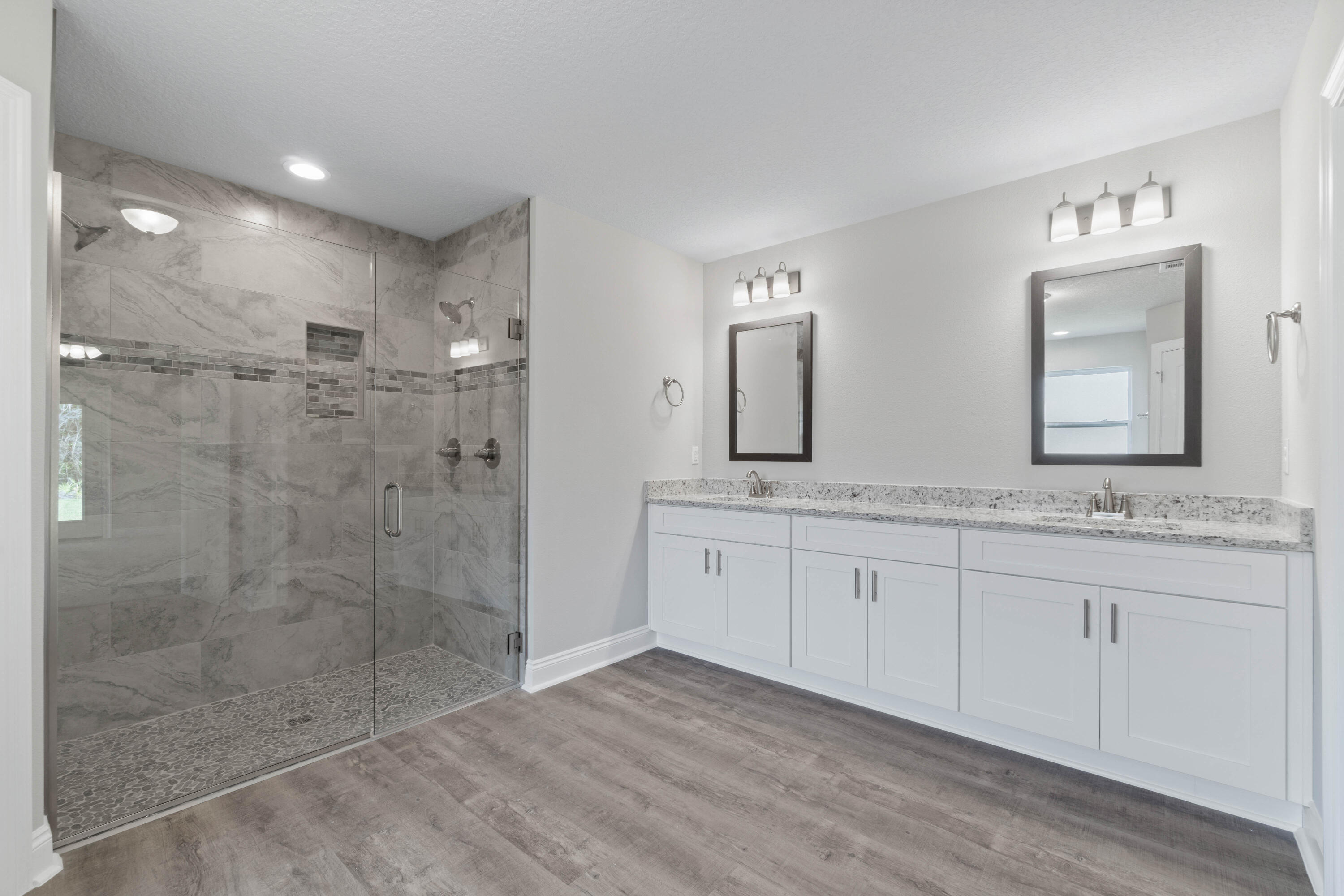 3548 Bob Tolbert Road Navarre, FL 32566 - Photo 22 of 47 a spacious bathroom with double vanity and a mirror