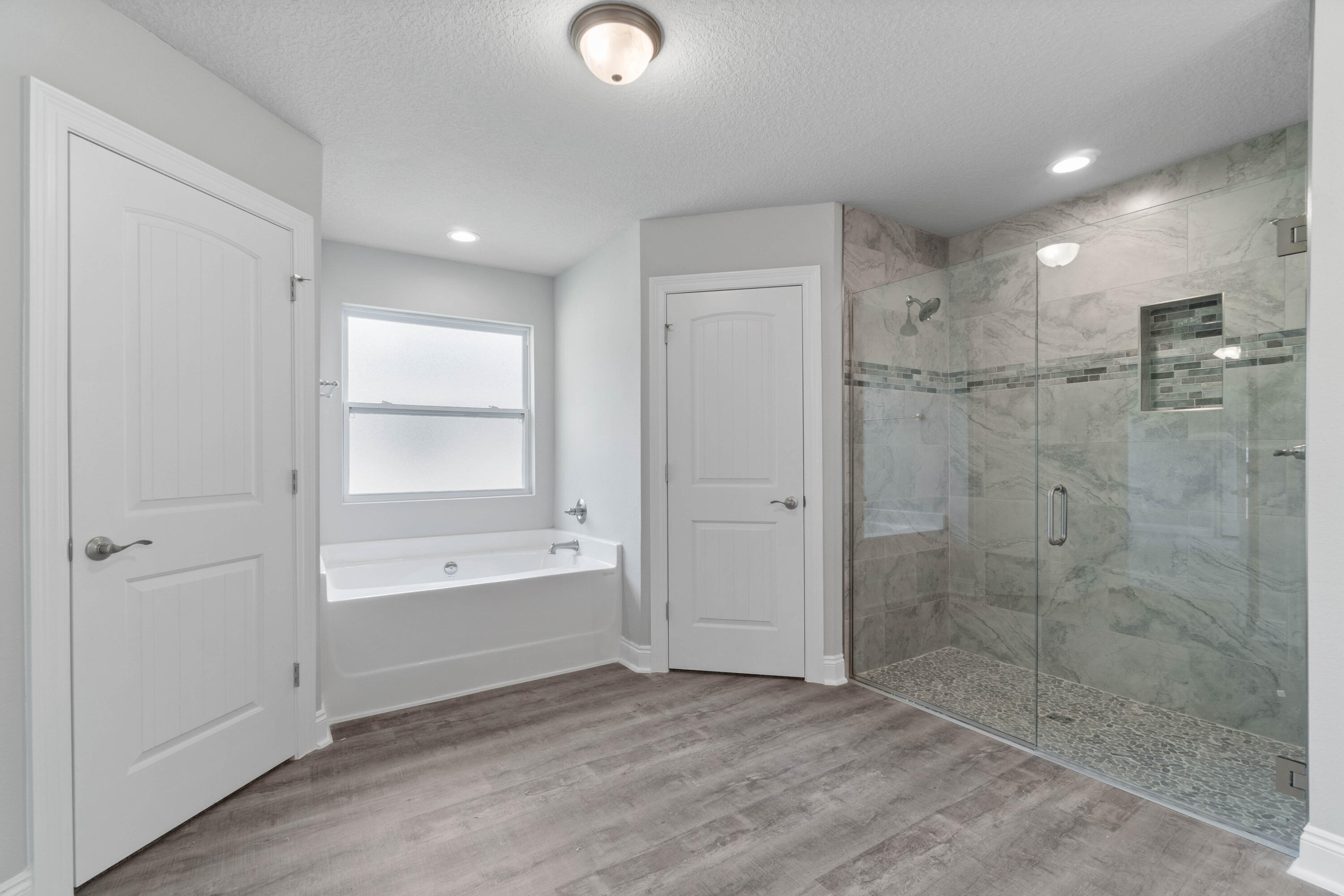 3548 Bob Tolbert Road Navarre, FL 32566 - Photo 24 of 47 a bathroom with a bathtub and a shower