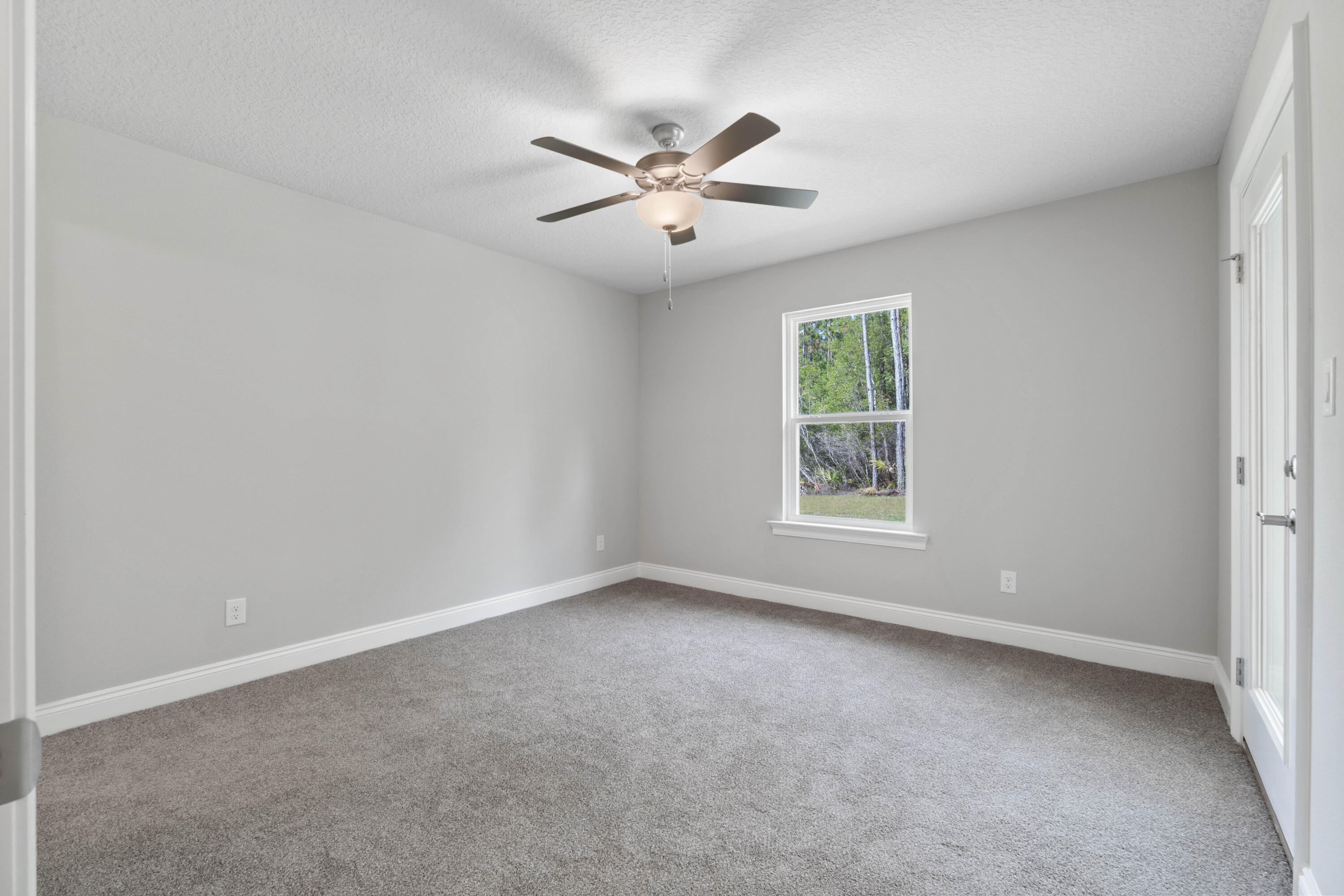 3548 Bob Tolbert Road Navarre, FL 32566 - Photo 29 of 47 a view of a big room with windows and chandelier fan