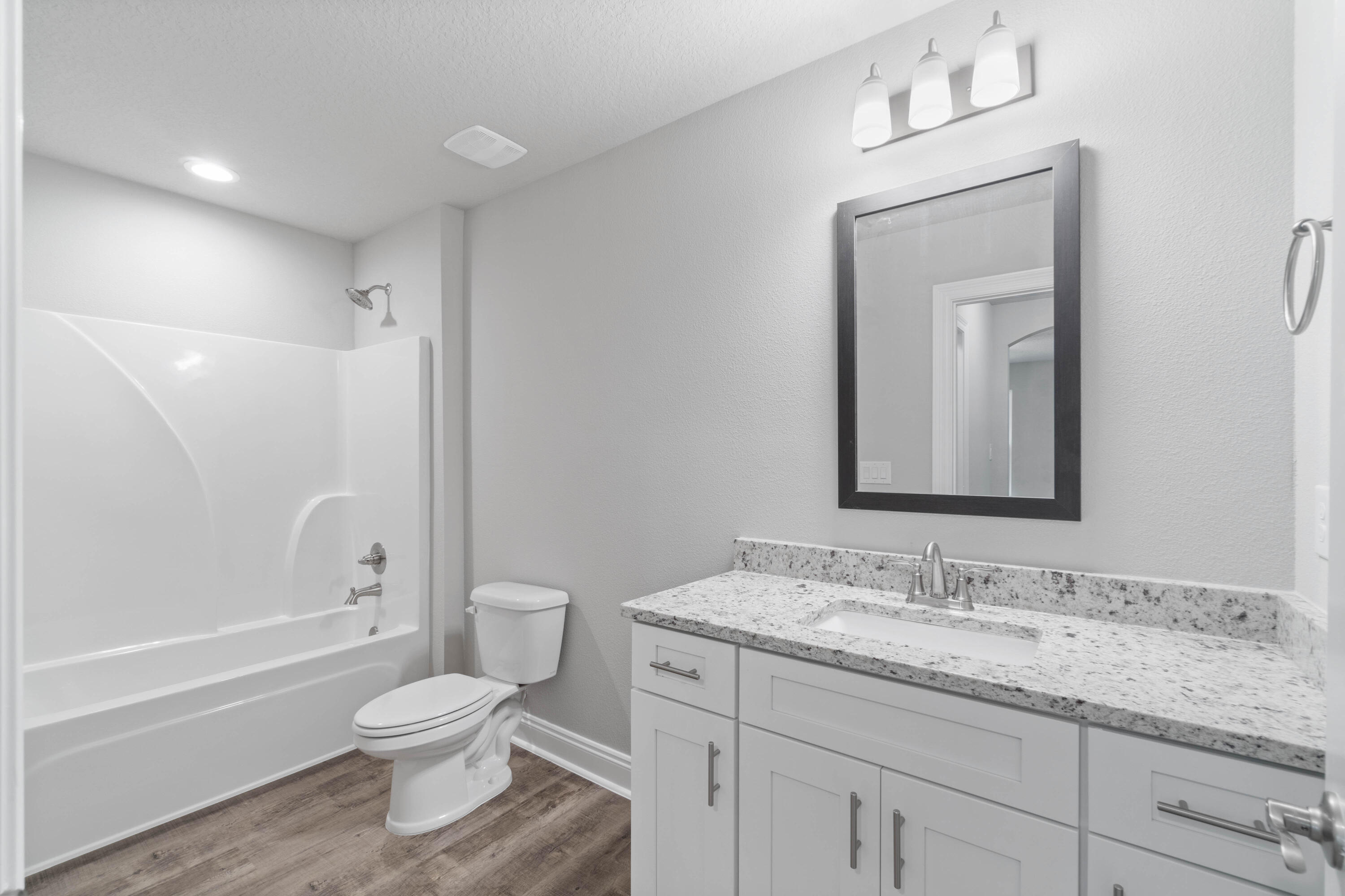 3548 Bob Tolbert Road Navarre, FL 32566 - Photo 33 of 47 a bathroom with a granite countertop toilet a sink and a bathtub
