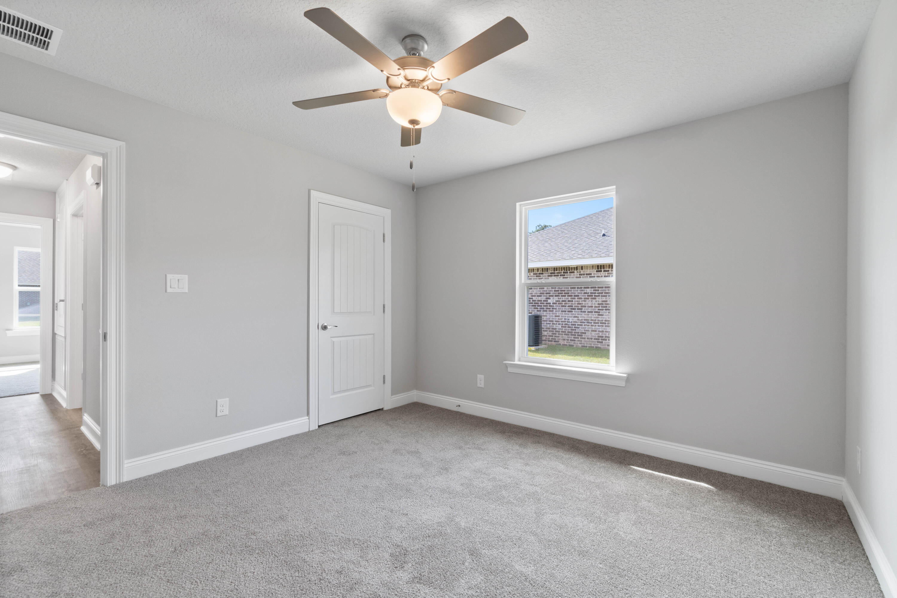 3548 Bob Tolbert Road Navarre, FL 32566 - Photo 35 of 47 an empty room with a window and a fan