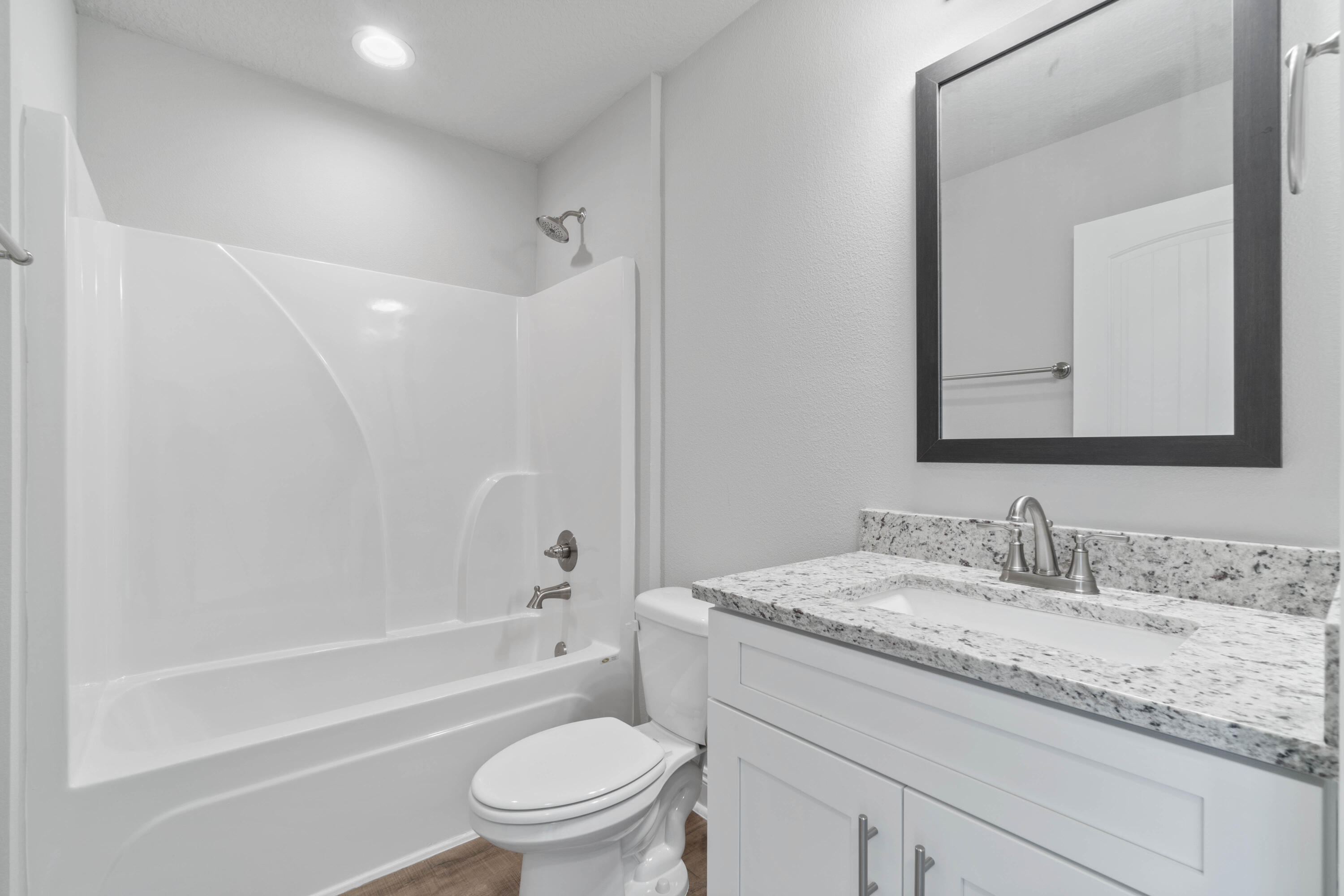 3548 Bob Tolbert Road Navarre, FL 32566 - Photo 36 of 47 a bathroom with a granite countertop toilet a sink and a bathtub