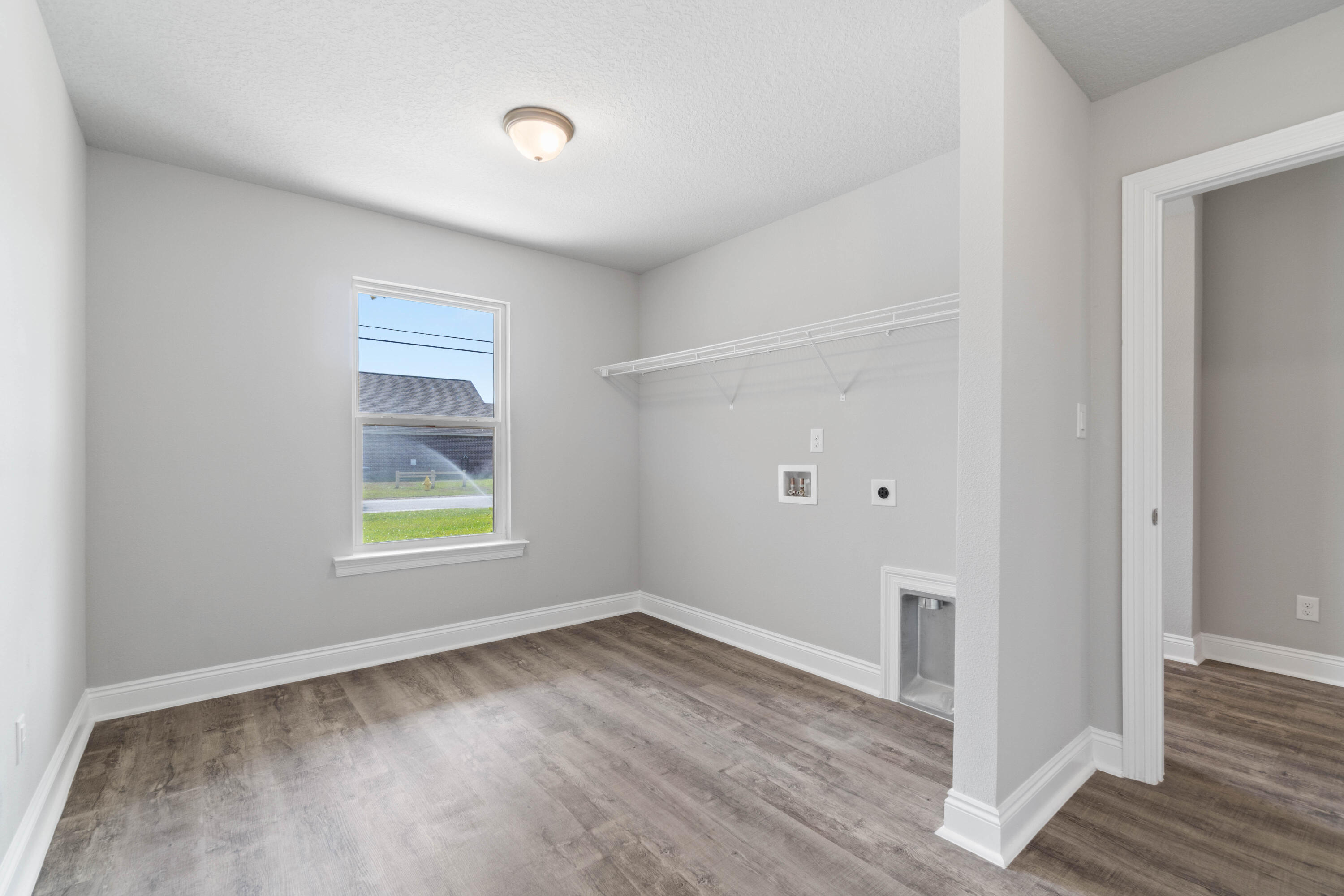 3548 Bob Tolbert Road Navarre, FL 32566 - Photo 39 of 47 an empty room with wooden floor and window