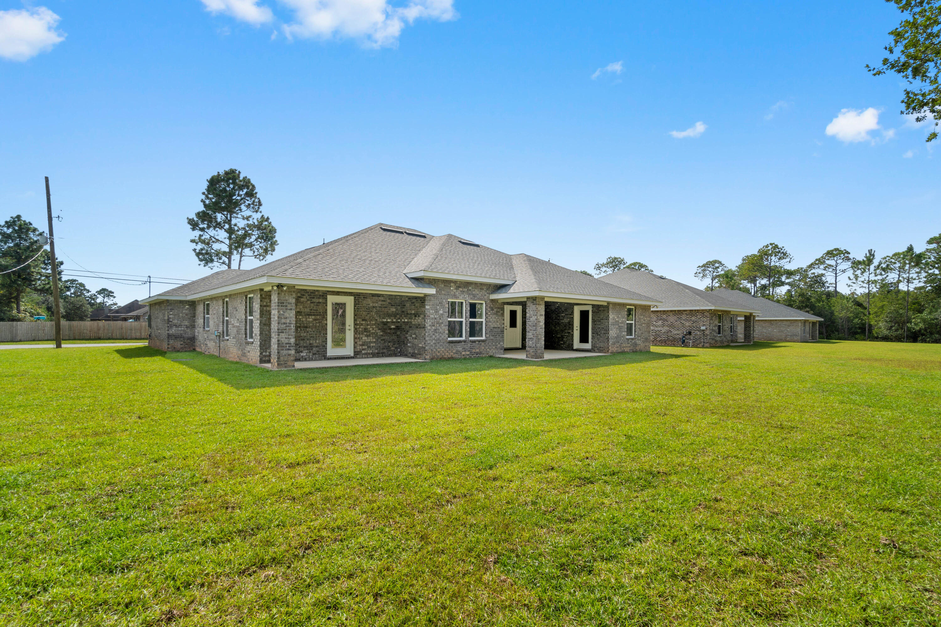3548 Bob Tolbert Road Navarre, FL 32566 - Photo 45 of 47 a front view of a house with a garden
