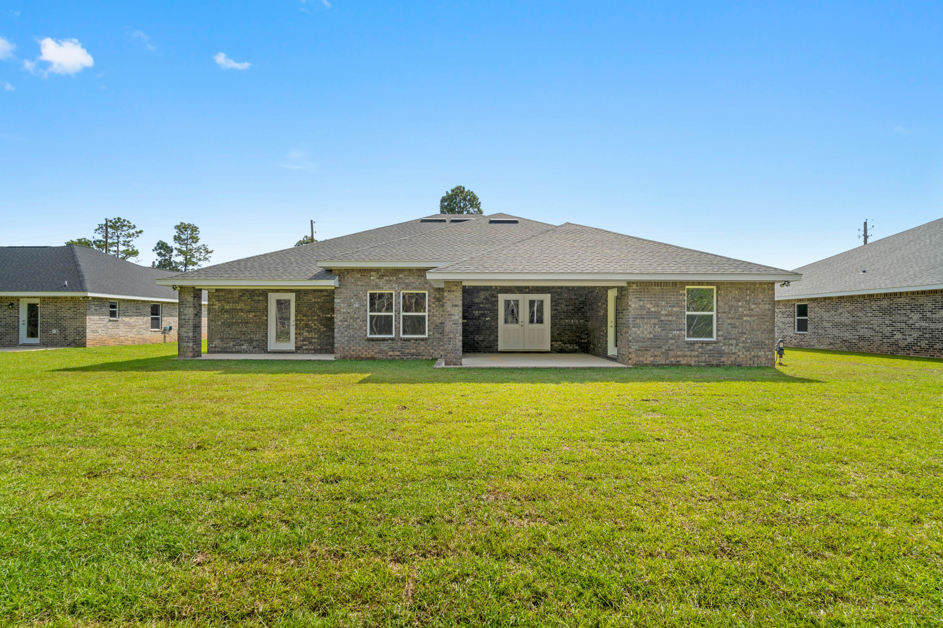 3548 Bob Tolbert Road Navarre, FL 32566 - Photo 46 of 47 a front view of a house with a garden