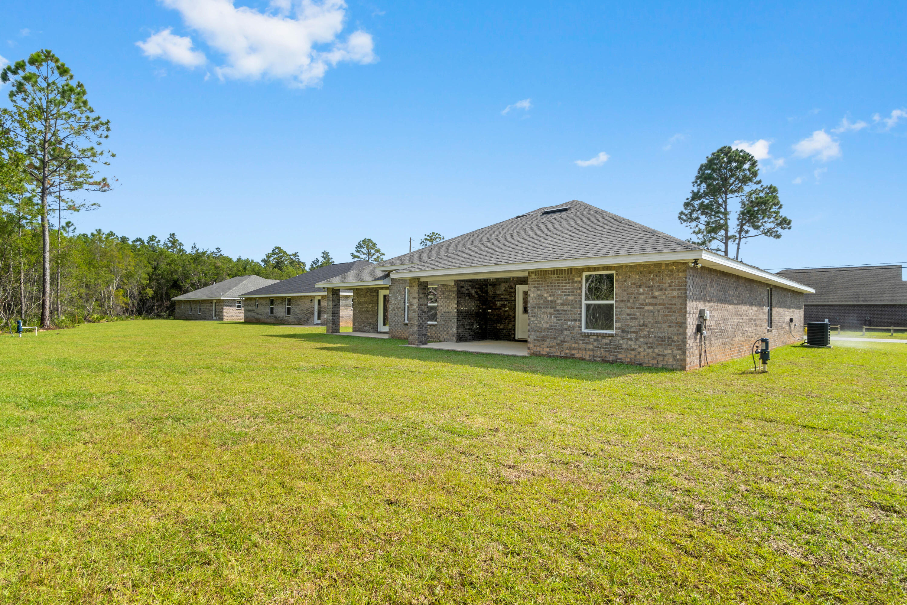3548 Bob Tolbert Road Navarre, FL 32566 - Photo 47 of 47 a front view of a house with a garden