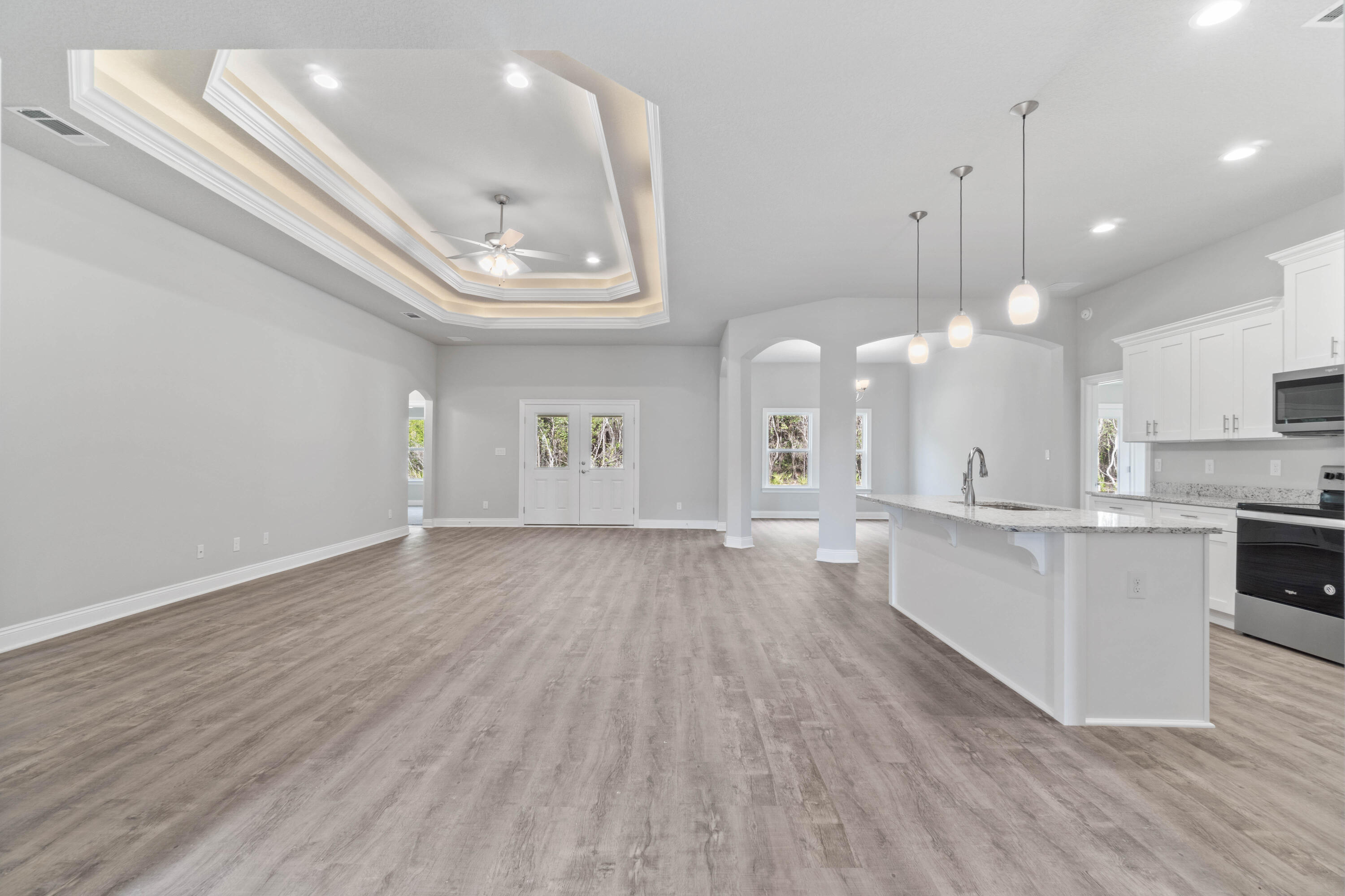 3548 Bob Tolbert Road Navarre, FL 32566 - Photo 5 of 47 a view of an empty room and kitchen with wooden floor