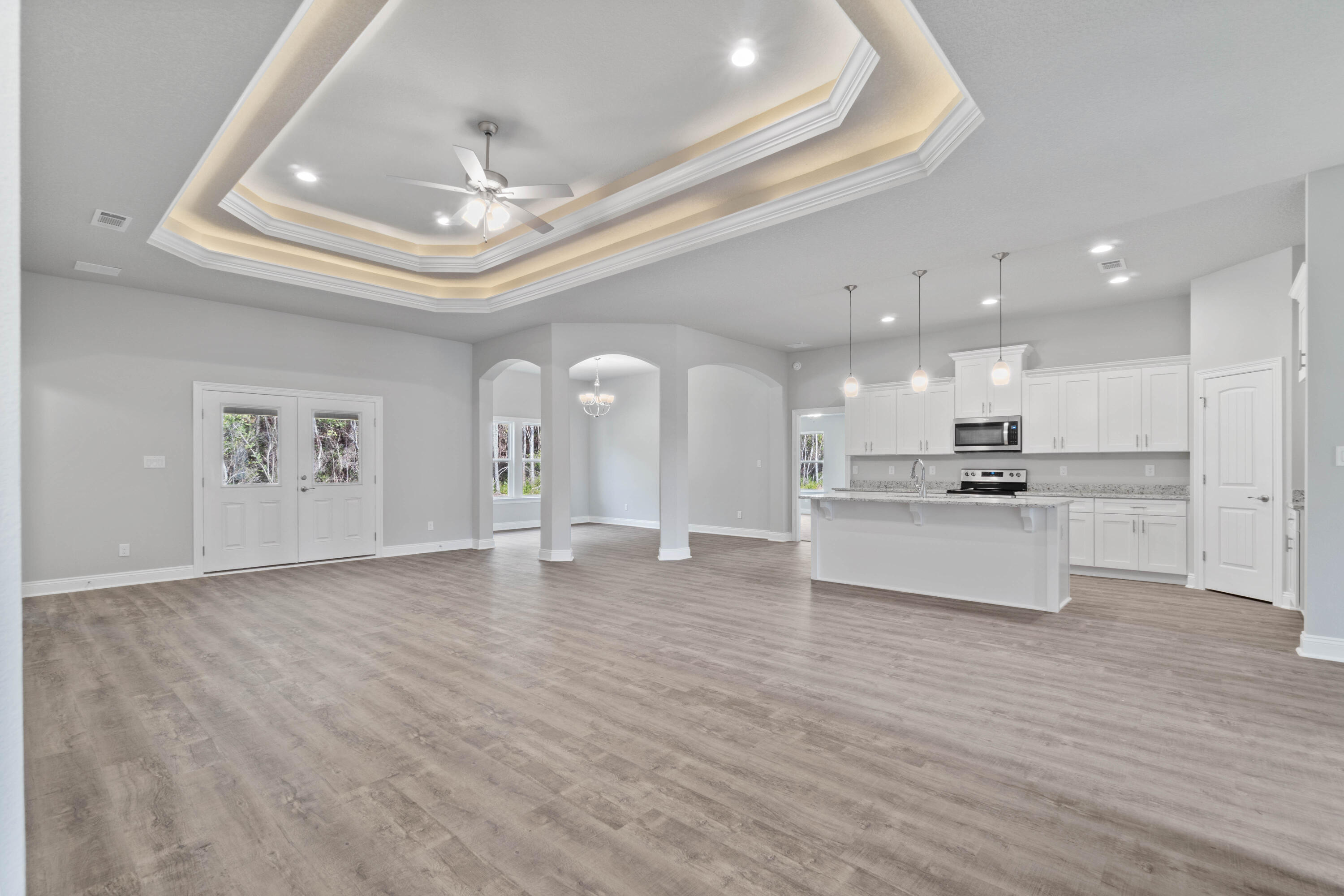 3548 Bob Tolbert Road Navarre, FL 32566 - Photo 7 of 47 a view of an empty room and kitchen with wooden floor