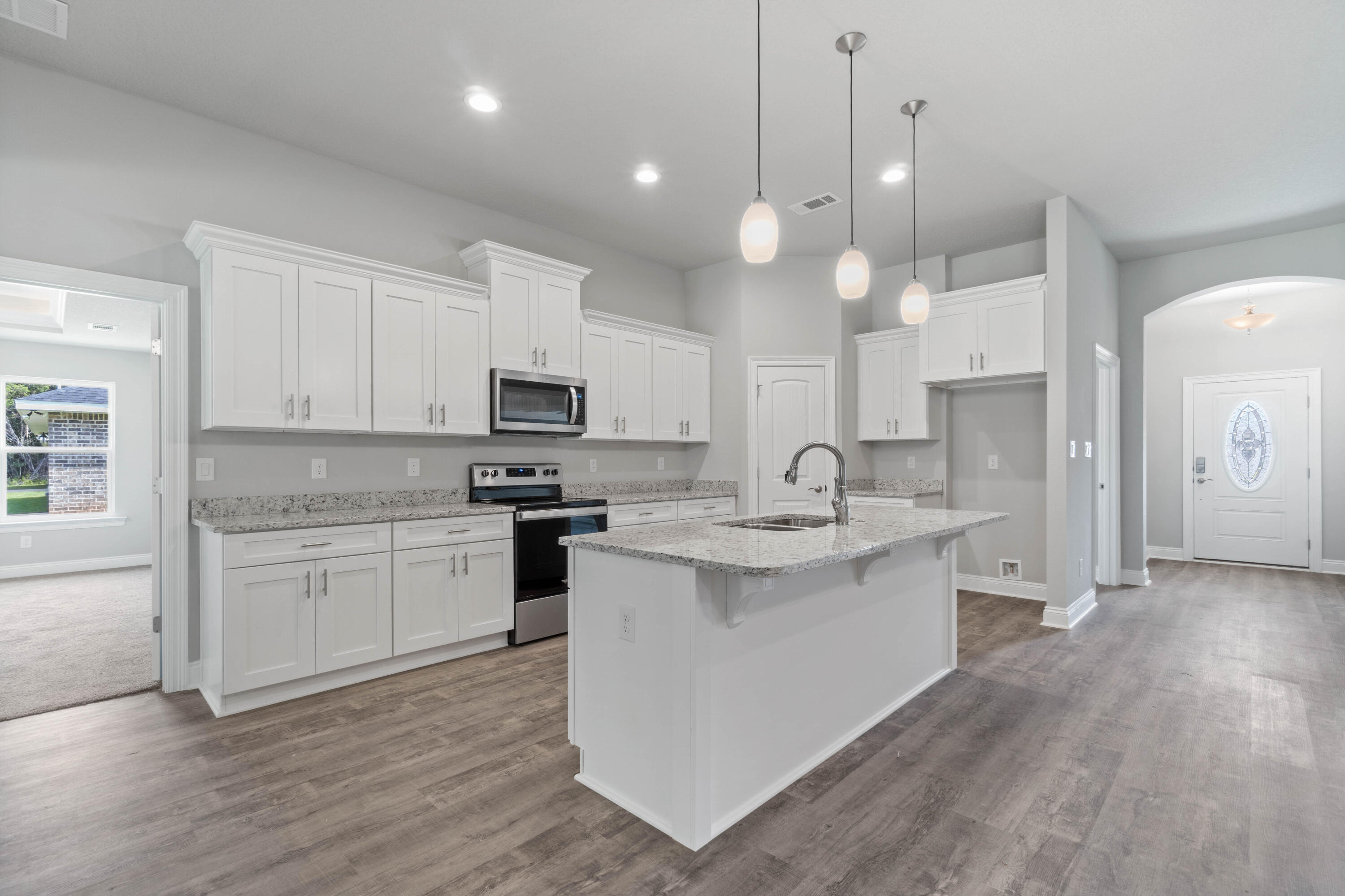 3548 Bob Tolbert Road Navarre, FL 32566 - Photo 10 of 47 a kitchen with a sink stove and cabinets