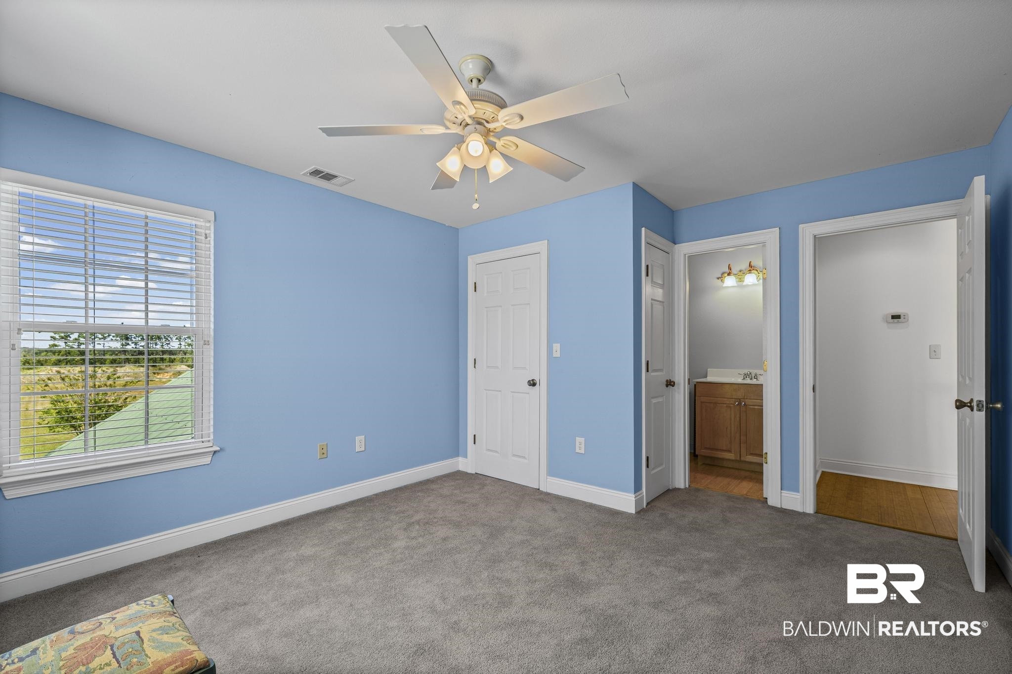 32875 Faircloth Road Lillian, AL 36549 - Photo 45 of 85 Unfurnished bedroom with dark carpet, a ceiling fan, ensuite bath, and a closet
