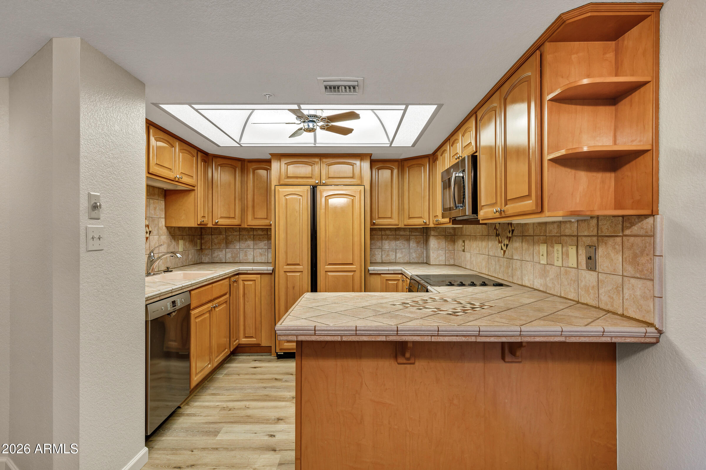 4200 North Miller Road, Unit 321 Scottsdale, AZ 85251 - Photo 21 of 41 a kitchen with stainless steel appliances granite countertop a sink and cabinets