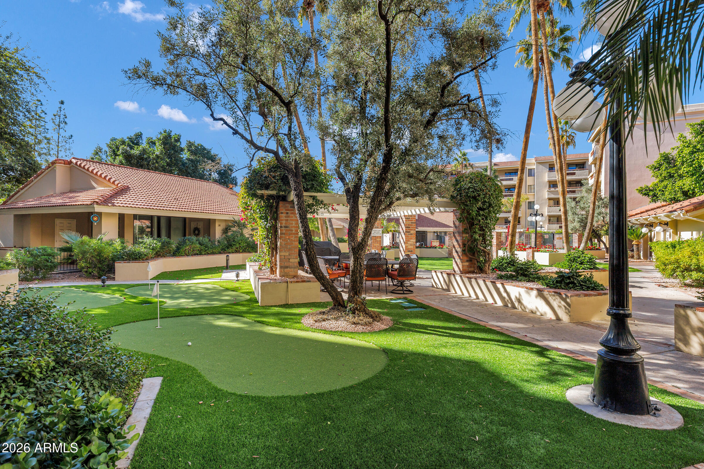 4200 North Miller Road, Unit 321 Scottsdale, AZ 85251 - Photo 3 of 41 a view of a house with garden and a patio