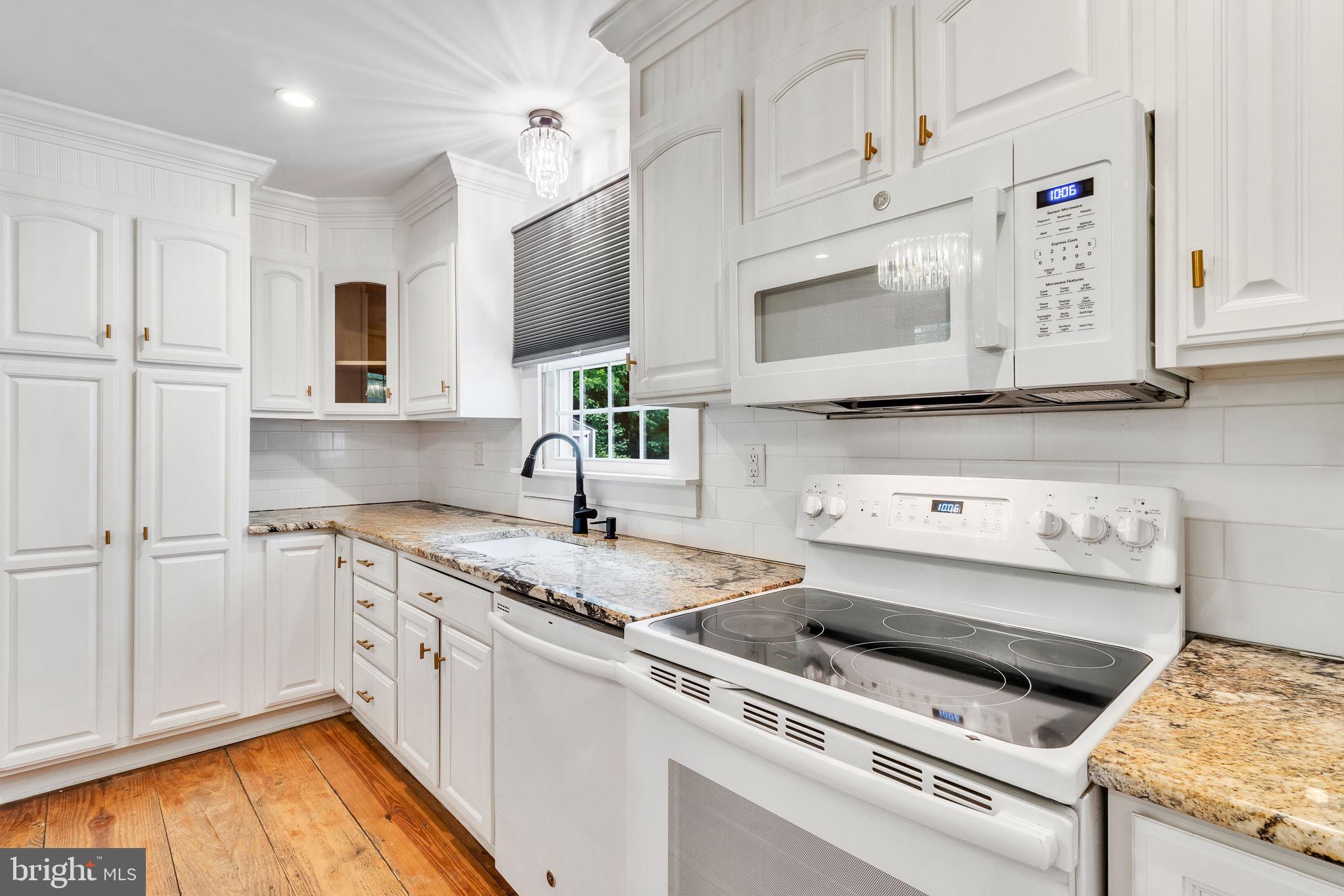 3952 Irvington Road Irvington, VA 22480 - Photo 19 of 77 a kitchen with stainless steel appliances granite countertop a sink and a stove